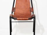 a brown leather chair with black legs and a black frame
