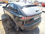 the rear end of a black bmw suv parked in a parking lot