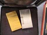 two lighters sitting in a case on a table
