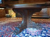 a large wooden table on a rug in a room