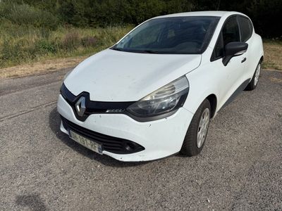 the white car is parked on the side of the road