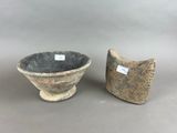 pair of stoneware vases on a gray surface with a tag on the side