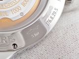 a close up of a watch on a white cloth