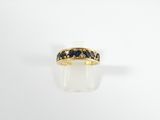 a close up of a gold ring with blue sapphire stones