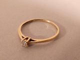 a picture of a gold ring with a diamond on it