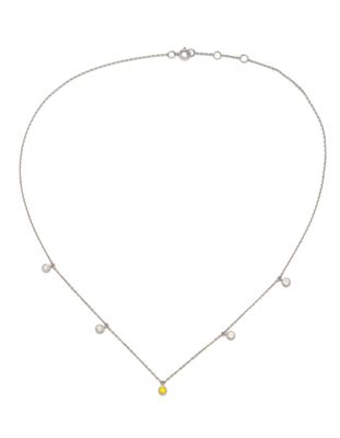a silver necklace with a yellow stone on a chain