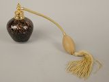 an image of a black and gold vase with a tassel