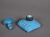 a small blue object with a ring on top of it