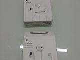 two apple earphones in the box on the table