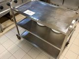 a stainless steel table in the middle of a kitchen