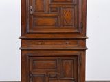 an old wooden cabinet with two doors on top of it