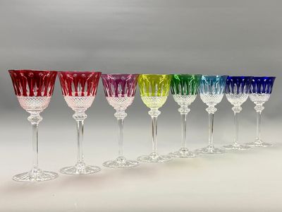 six different colored wine glasses lined up in a row