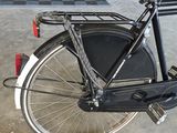 a bike that is parked in a garage with other bikes in the background