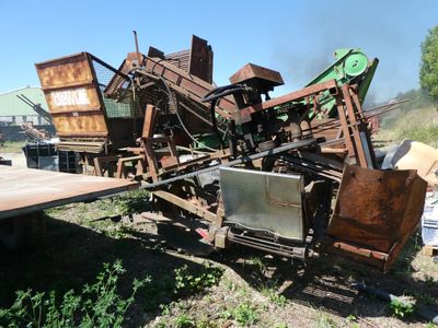 a pile of junk sitting on the ground next to a truck