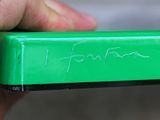 a person holding a green box with writing on it