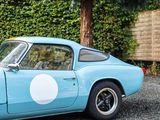 an image of a blue sports car parked in a parking lot