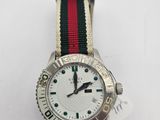 a close up of a wrist watch with a red, white, and green striped band