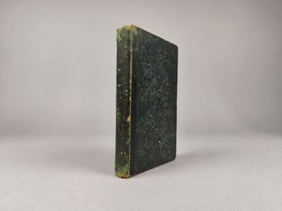 un vieux livre posé sur une surface blanche