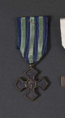 two medals and a cross on a black background