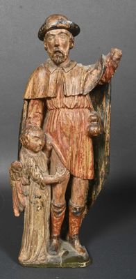 an old wooden statue of a man holding a child and a dog
