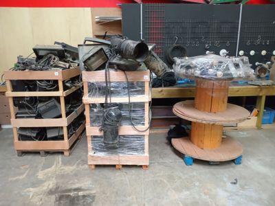 a pile of assorted items sitting on a table in a garage