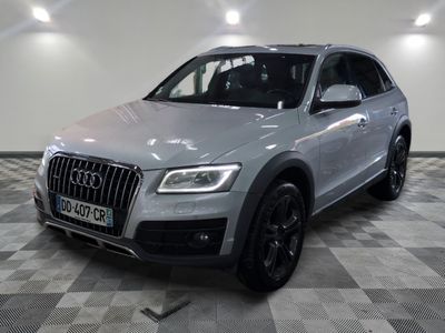 the audi qx is parked on a checkered floor in a garage
