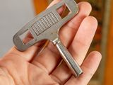 a person holding a bottle opener in their hand