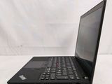 a black laptop computer sitting on a white surface