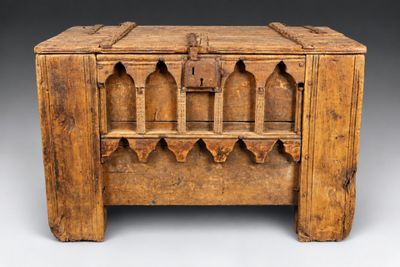 an old wooden chest with a lock on top of it