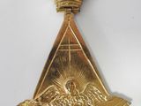 an image of a gold medal with a crown on top of it