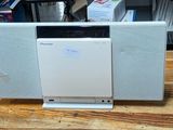 a white dishwasher sitting on top of a wooden table