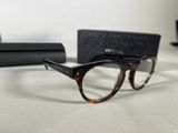a pair of glasses sitting on a table next to a box