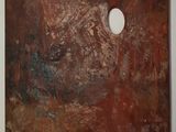 a close up of a paint palette with a hole in it