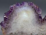 a close up of a piece of amethorate with purple and white crystals