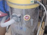 a yellow and white vacuum sitting in a room