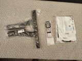 a pair of scissors sitting on a table next to a package of screws