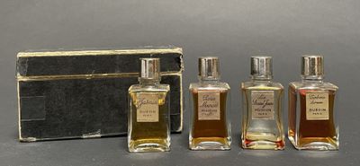three bottles of perfume sitting next to each other on a table