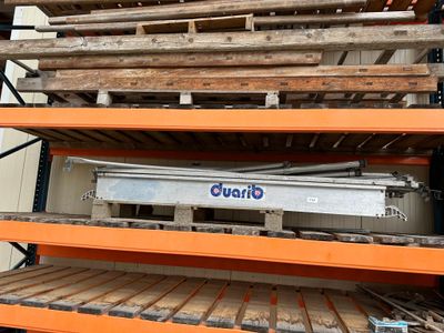 a stack of wooden pallets on a shelf in a warehouse
