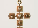 gold cross pendant with pearls and pearls on a black cord