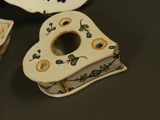 three pieces of porcelain that are on a table