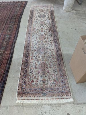 two rugs sitting on the floor next to a box
