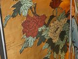 a painting of flowers on the side of a building