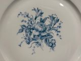 a blue and white plate with a floral design on it