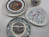 three plates and a vase on the table