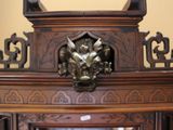 a large wooden cabinet with a mirror in it