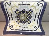 blue and white square scarf with a gold design on it