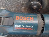 a close up of a drill on the ground near a fire hydrant