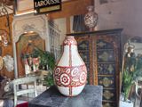 a vase sitting on top of a table in a room