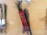 a display case with a pair of scissors and a pair of feathers