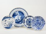 three blue and white plates with designs on them on a white surface